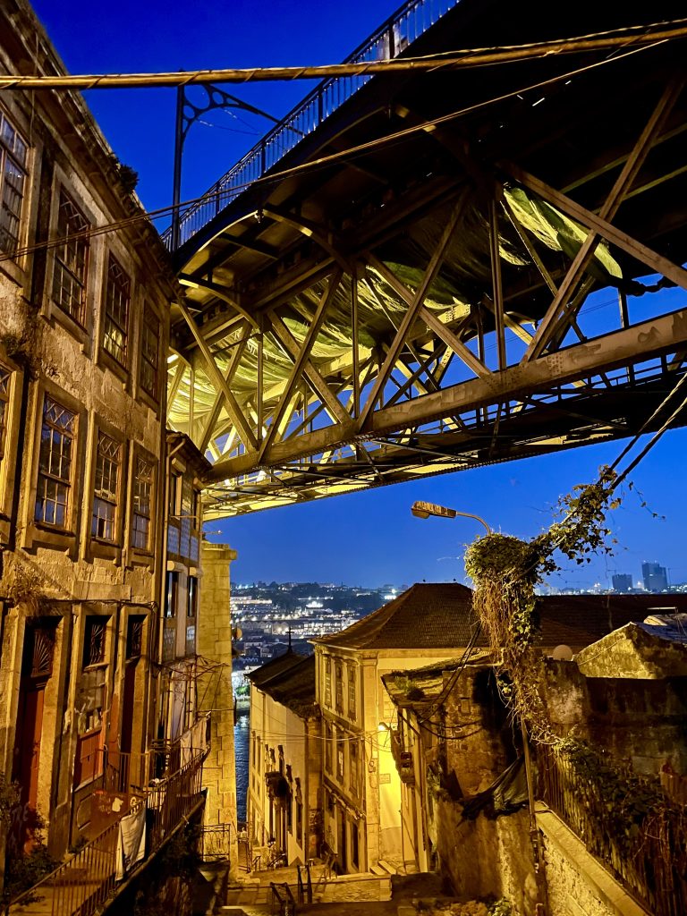 Walking under the Dom Luis I Bridge at night in Porto