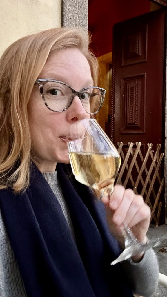Aimee sipping a glass of wine at Capela Incomum