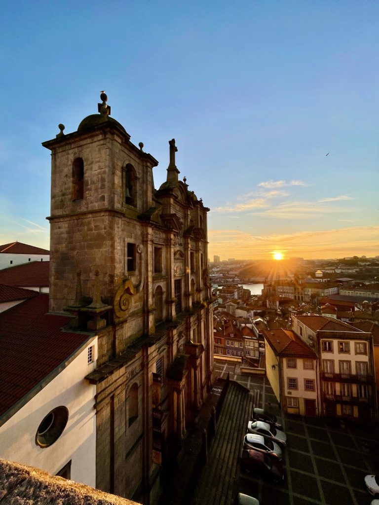 View of Igreja dos Grilos at sunset from the Miradouro da Rua das Aldas