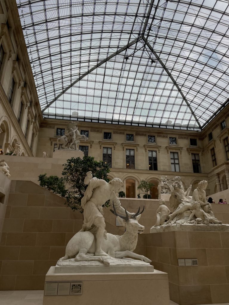 An atrium in the Louvre, filled with marble statues