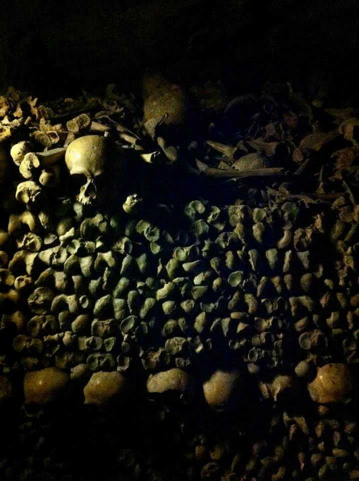 Skeletons neatly stacked in the Paris Catacombs