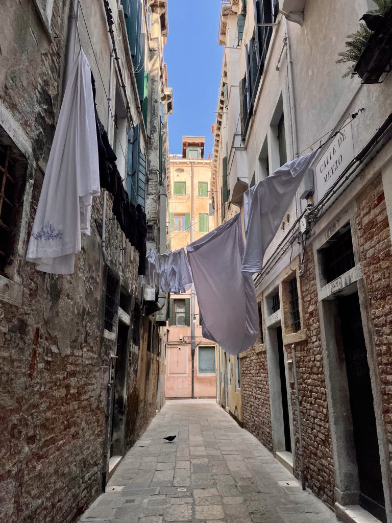 Clothes hanging from a clothing line in a Venice alleyway