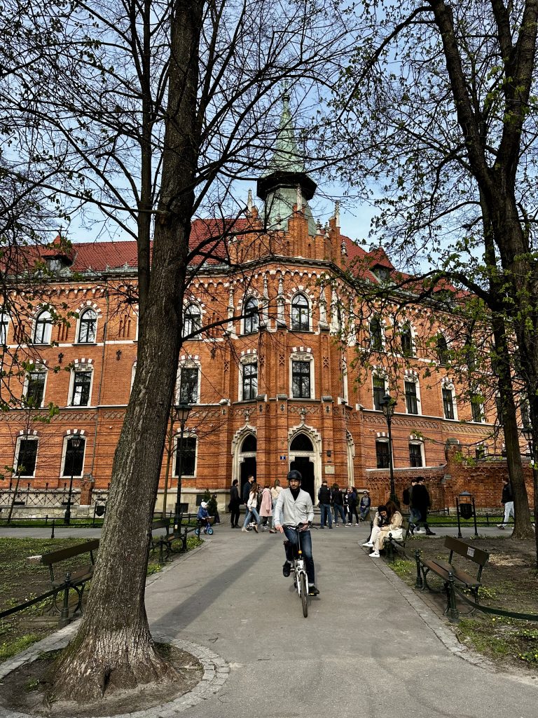 A person riding a bike in a park in Krakow