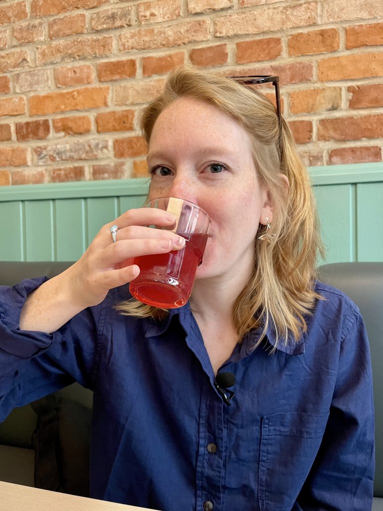 Aimee drinking kompot at Milkbar Tomasza